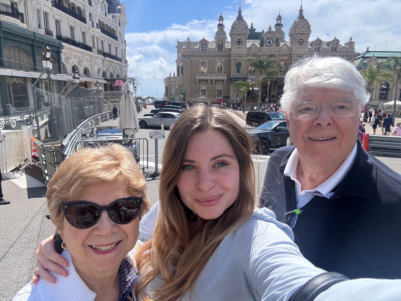 Tour guests taking a selfie in front of the Monte Carlo Casino in Monaco