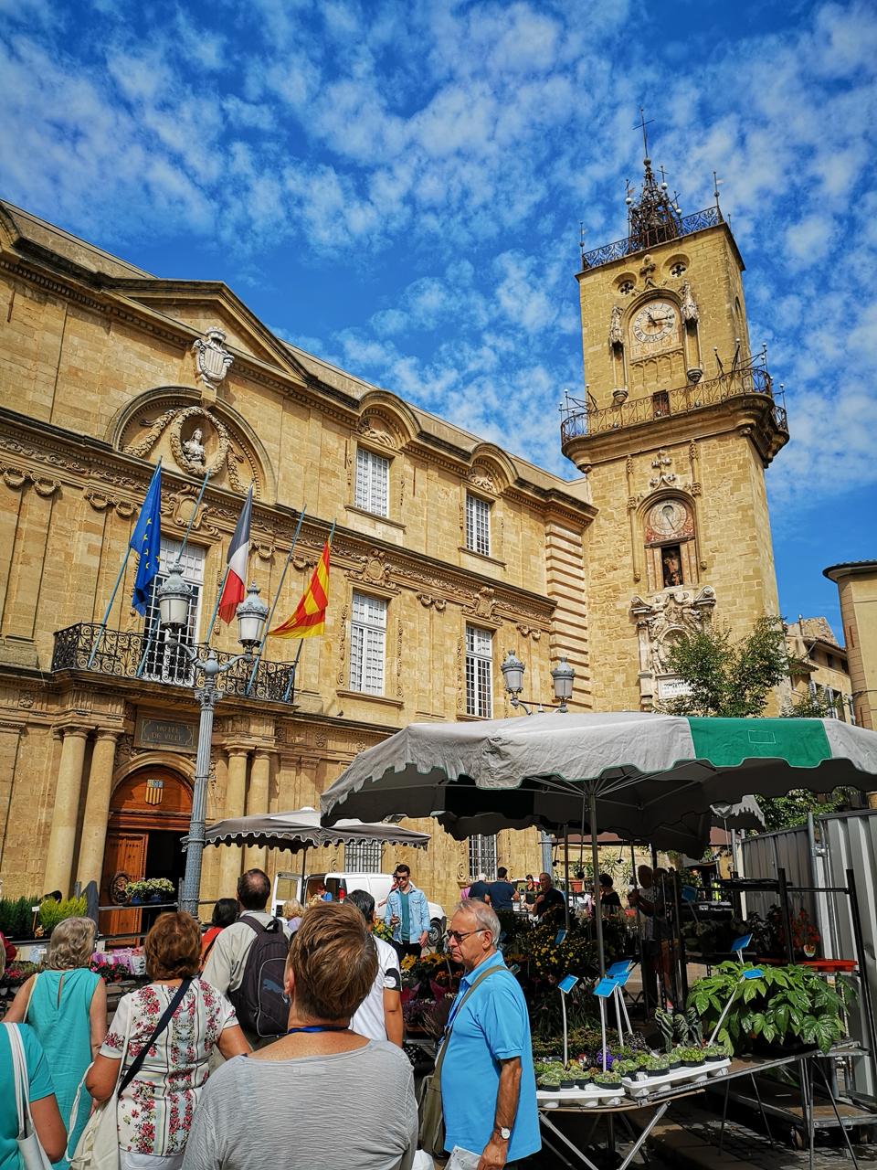 Provencal market square with obelisk fountain and town hall visited on the Luberon Hilltop Villages private tour