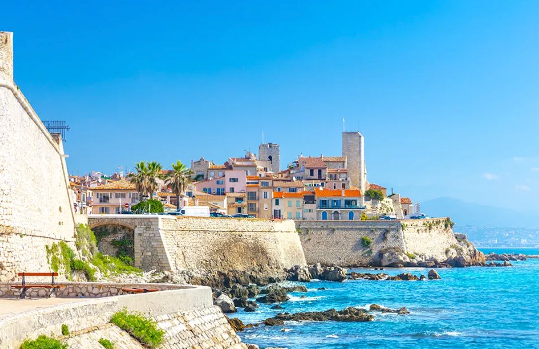 Antibes old town seen from the seaside ramparts above the turquoise Mediterranean