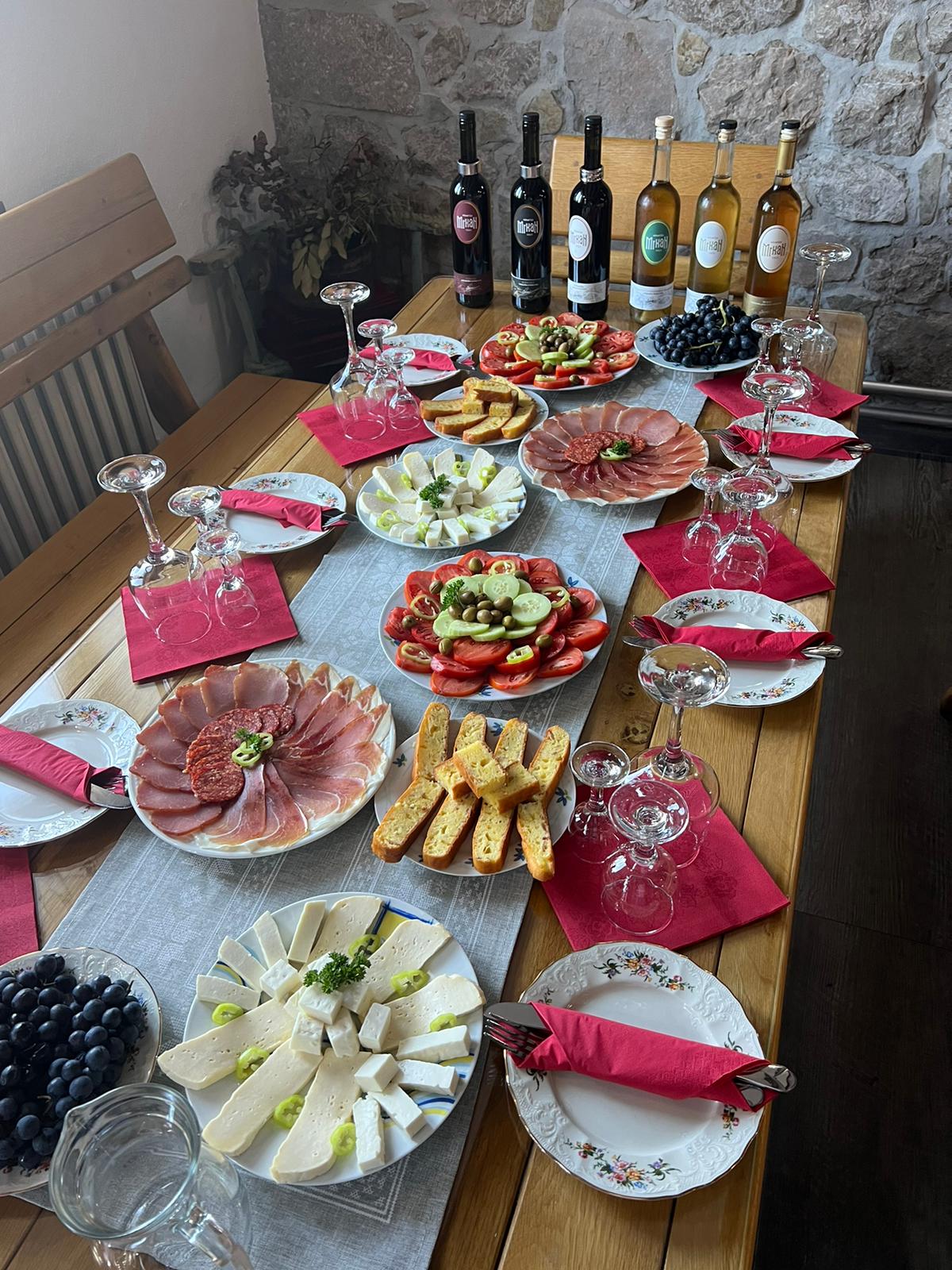 Table set with local Montenegrin cheeses, cured meats and boutique winery wines
