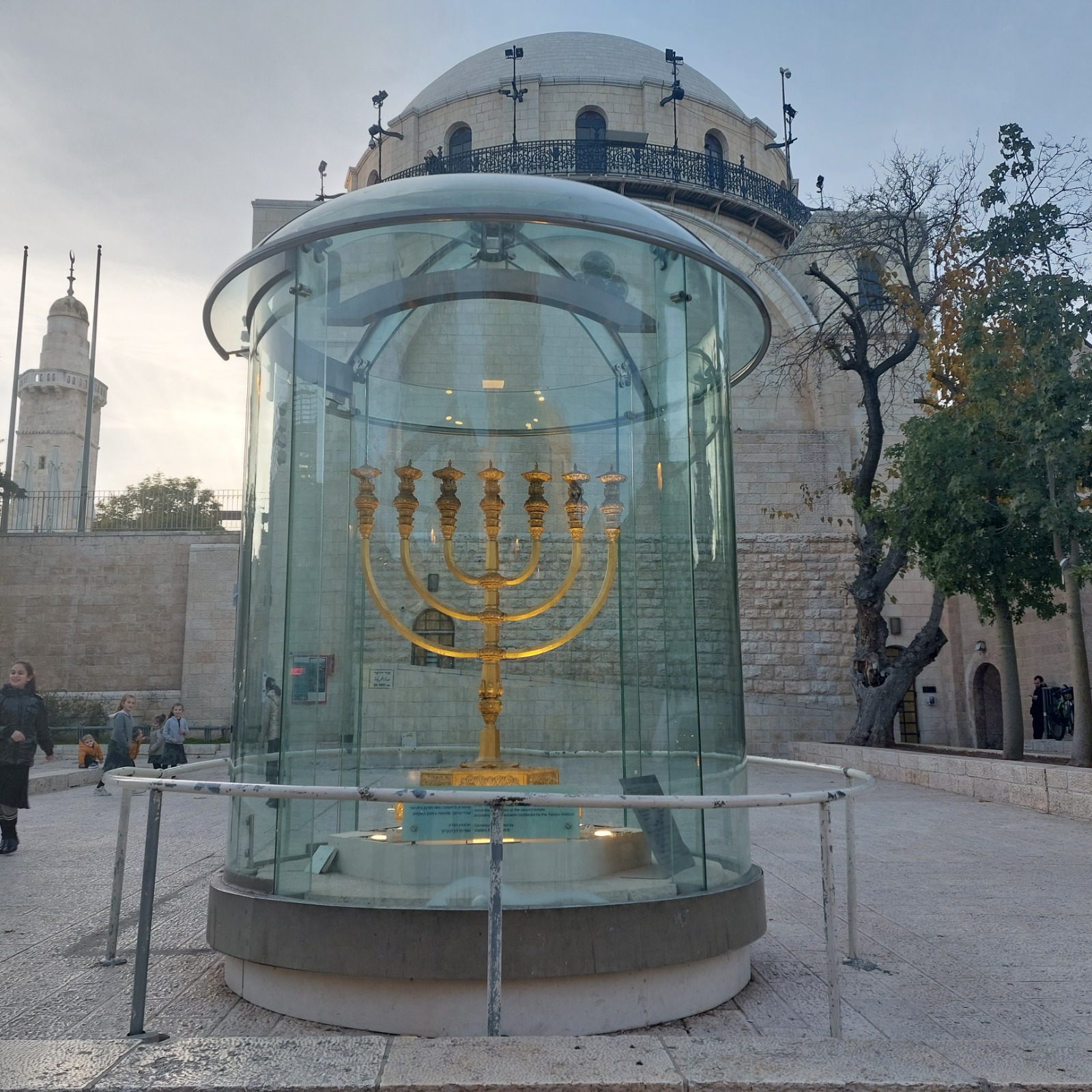 Golden seven-branched Menorah in the Jewish Quarter with the Hurva Synagogue dome behind
