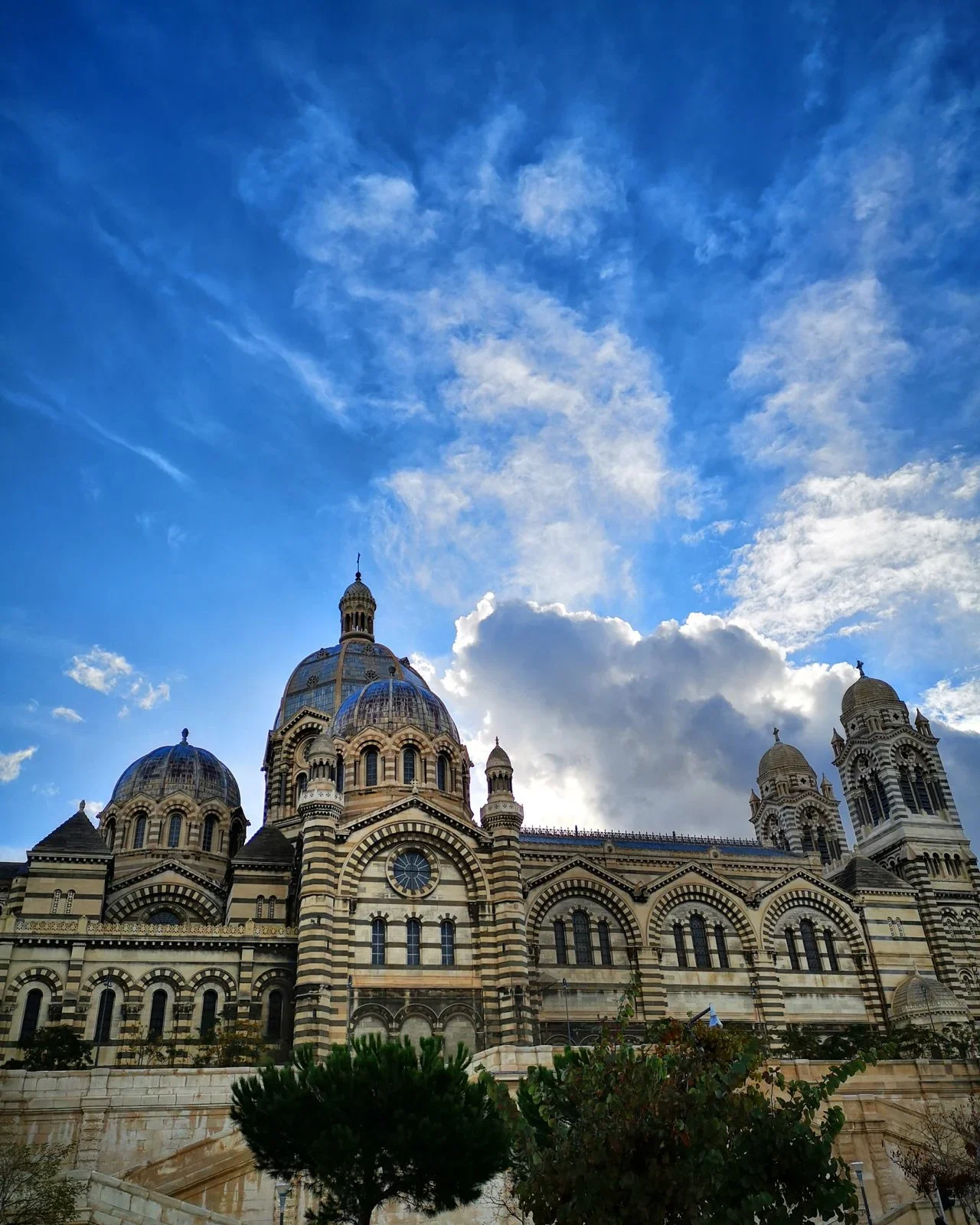 Marseille Cathedral de la Major with its striped stone domes under a blue sky