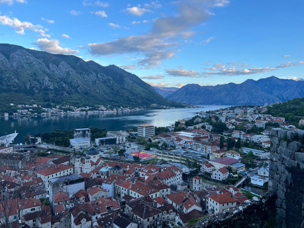 Panoramic view of Kotor old town rooftops and the Bay of Kotor at dusk