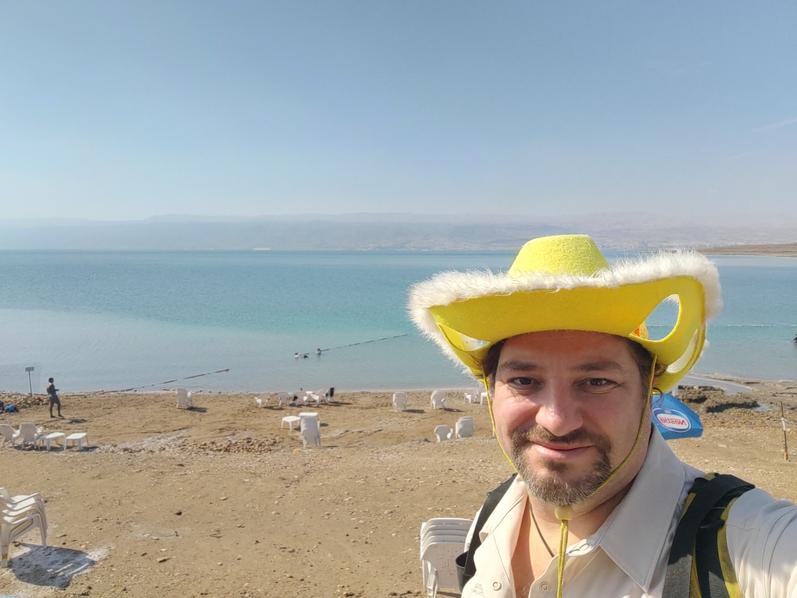 Guide Daniel in the yellow hat on the shore of the Dead Sea, the lowest point on earth