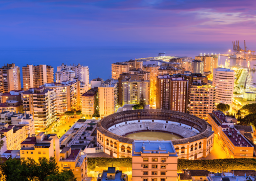 Aerial view of Malaga bullring and skyline at dusk