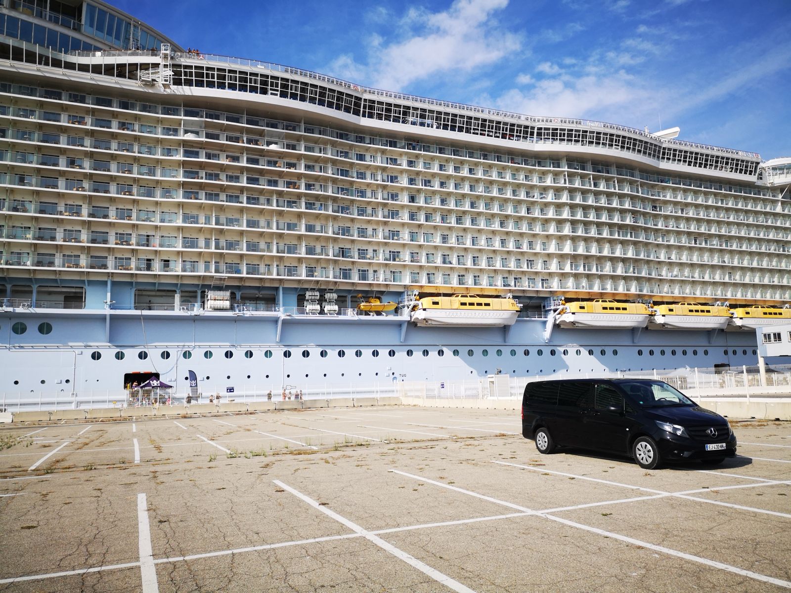 Private touring vehicle waiting beside a cruise ship at Toulon port