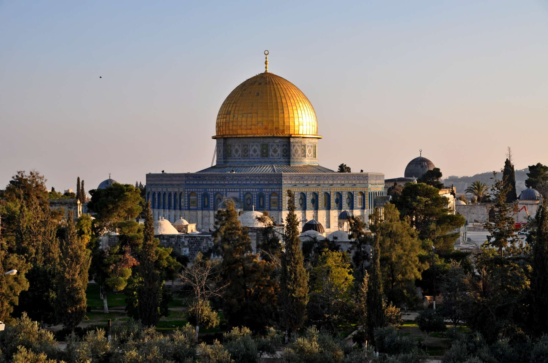 The golden Dome of the Rock shining above the trees of the Temple Mount, Jerusalem