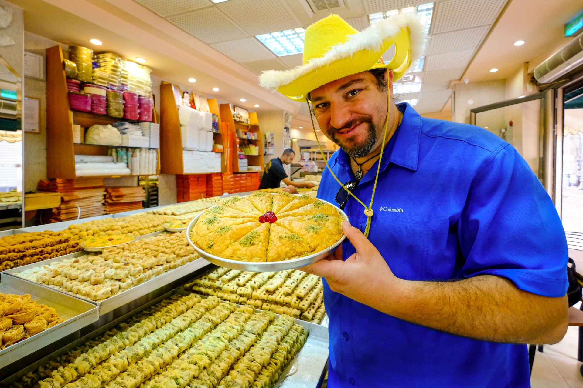 Daniel presenting baklava at a pastry shop