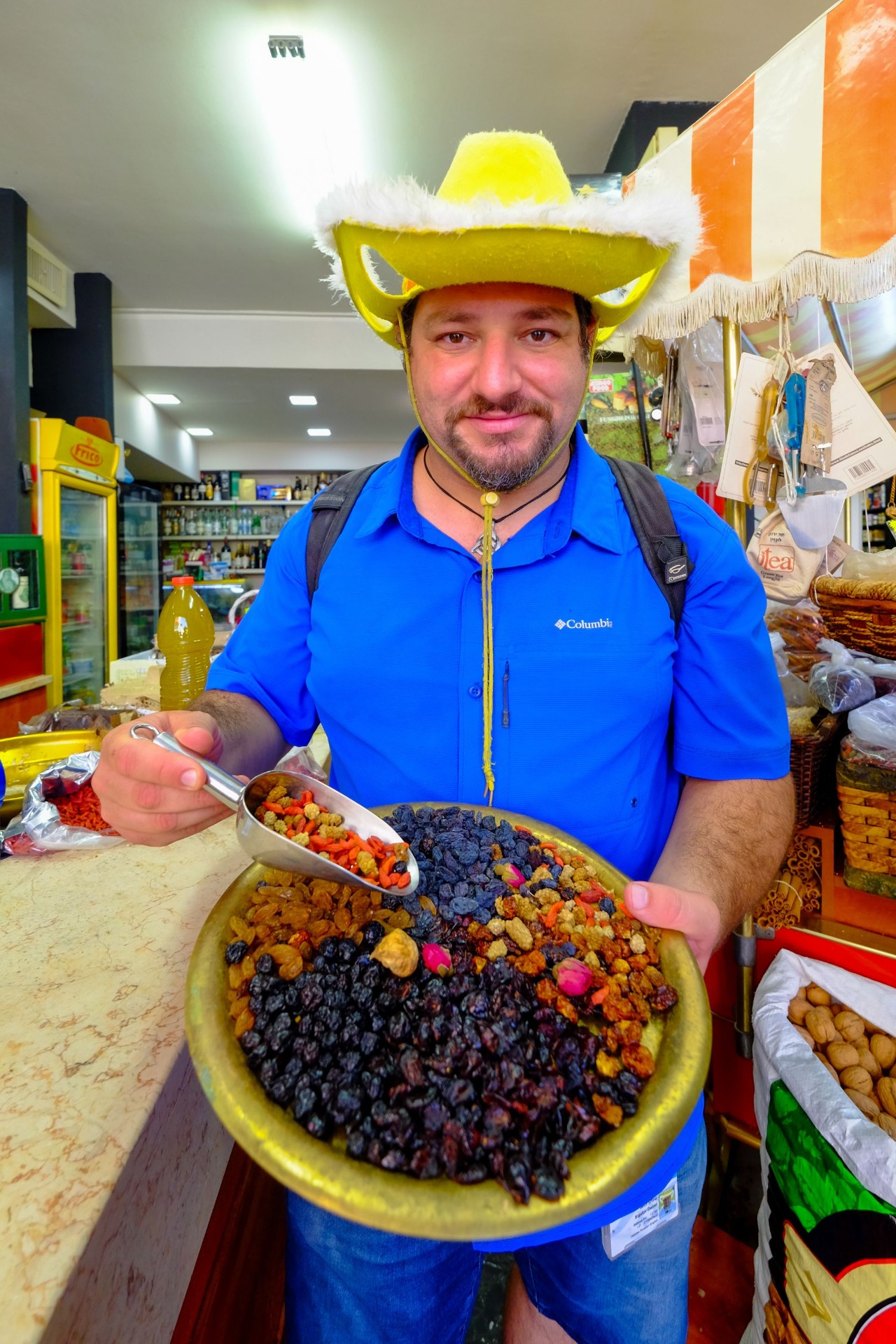 Daniel showing dried fruits and spices at the market
