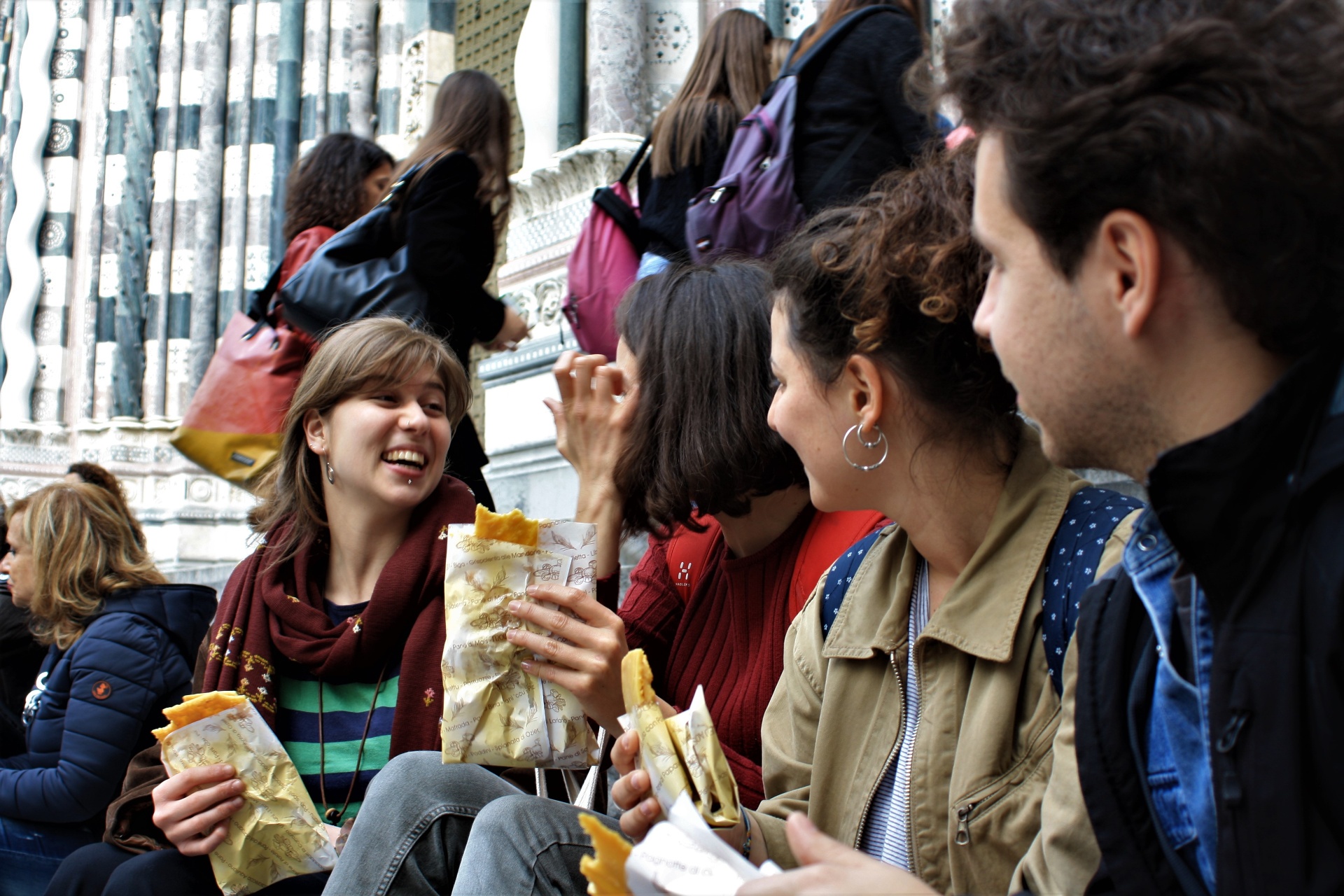 Tour guests enjoying street food by the cathedral