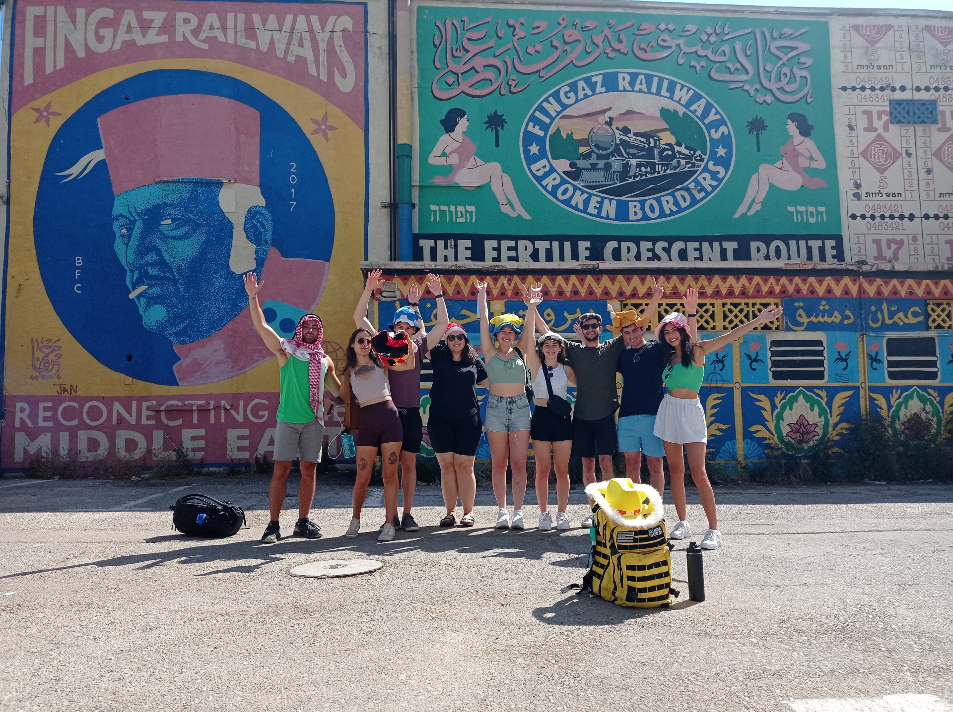 Group posing at Fingaz Railways mural