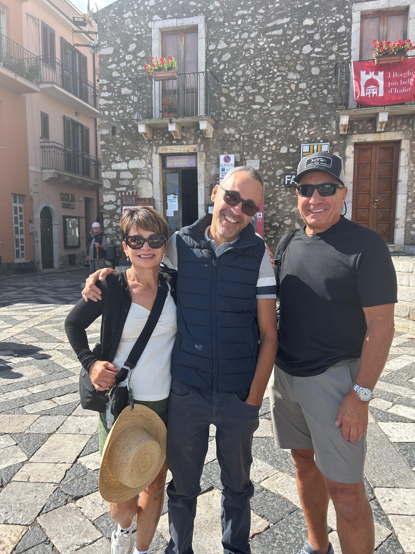 Guide with guests in Forza d'Agrò village square
