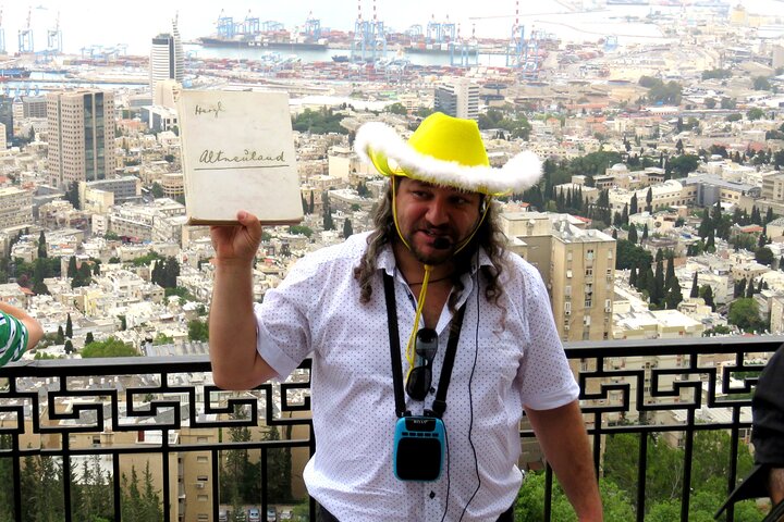 Daniel presenting Herzl's Altneuland book with Haifa panorama