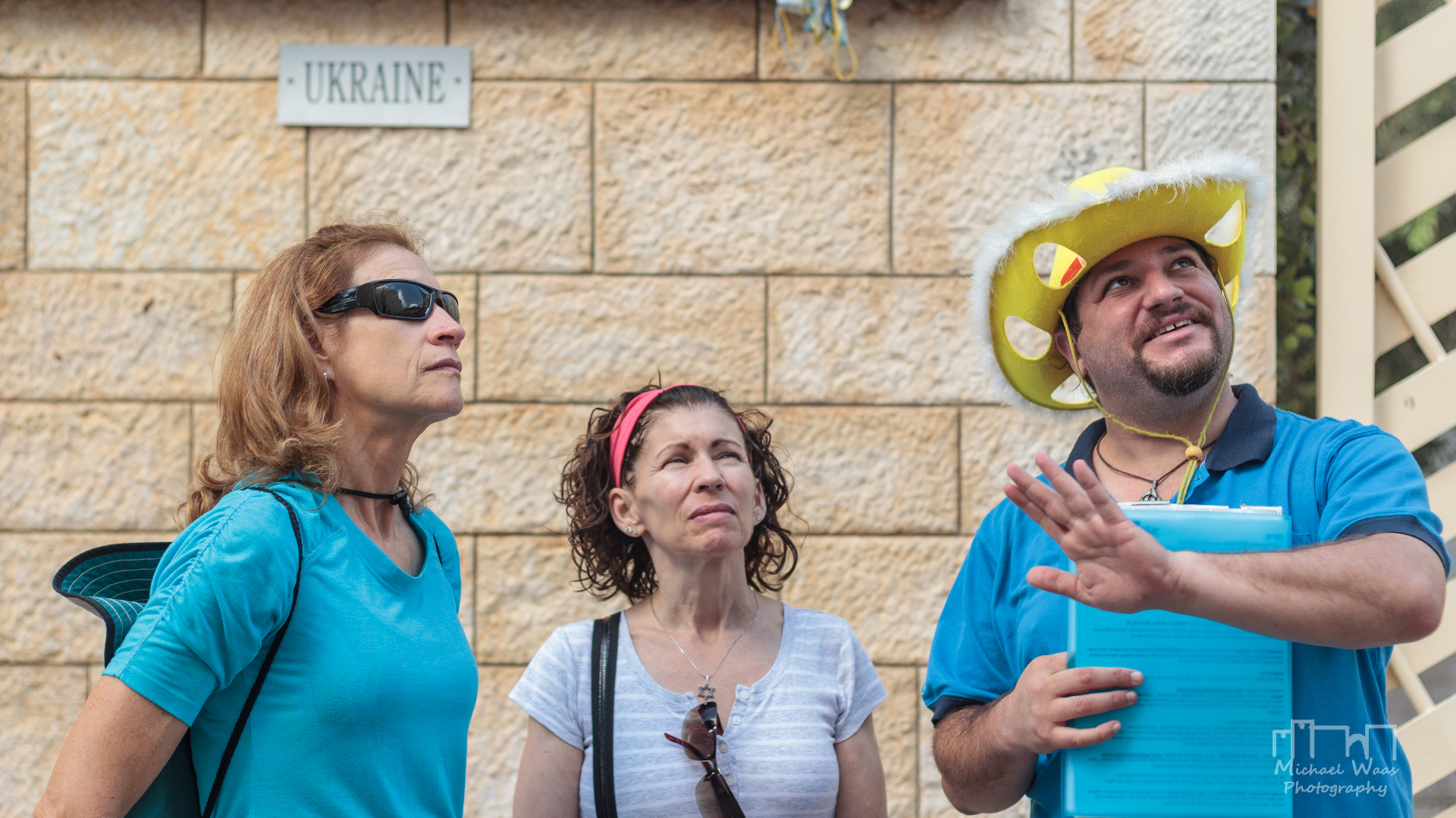 Daniel guiding tourists with his signature cheese hat